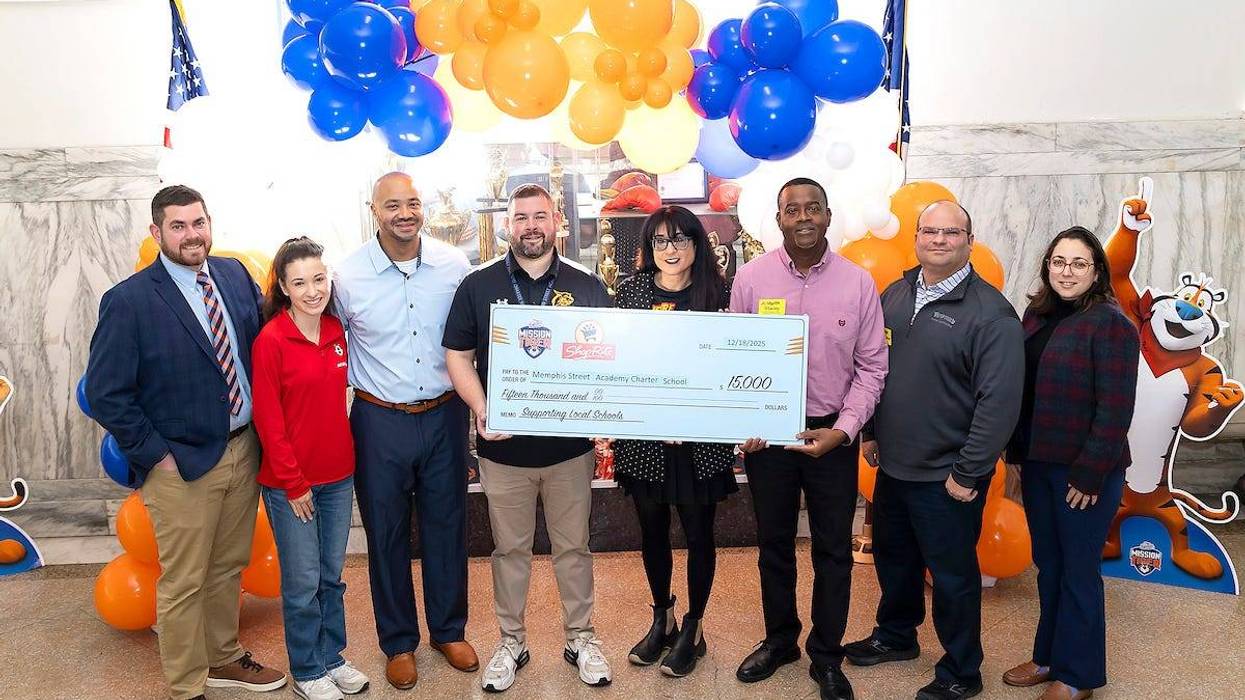 Leaders from the Memphis Street Academy Charter School pose with a check for $15,000.