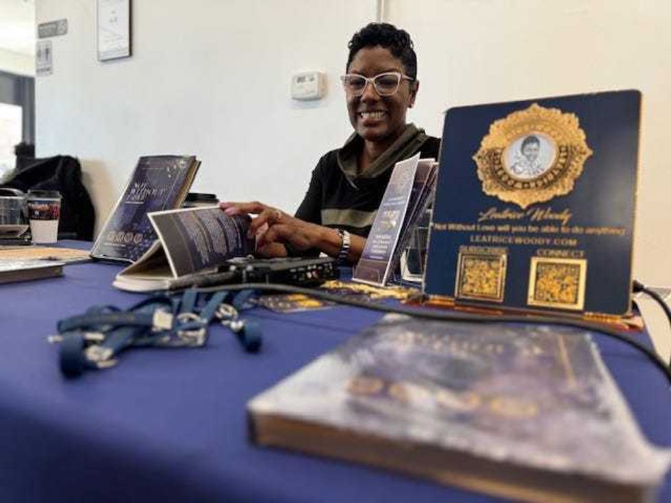 Leatrice Woody sets up her booth on behalf of the Not Without Love Foundation