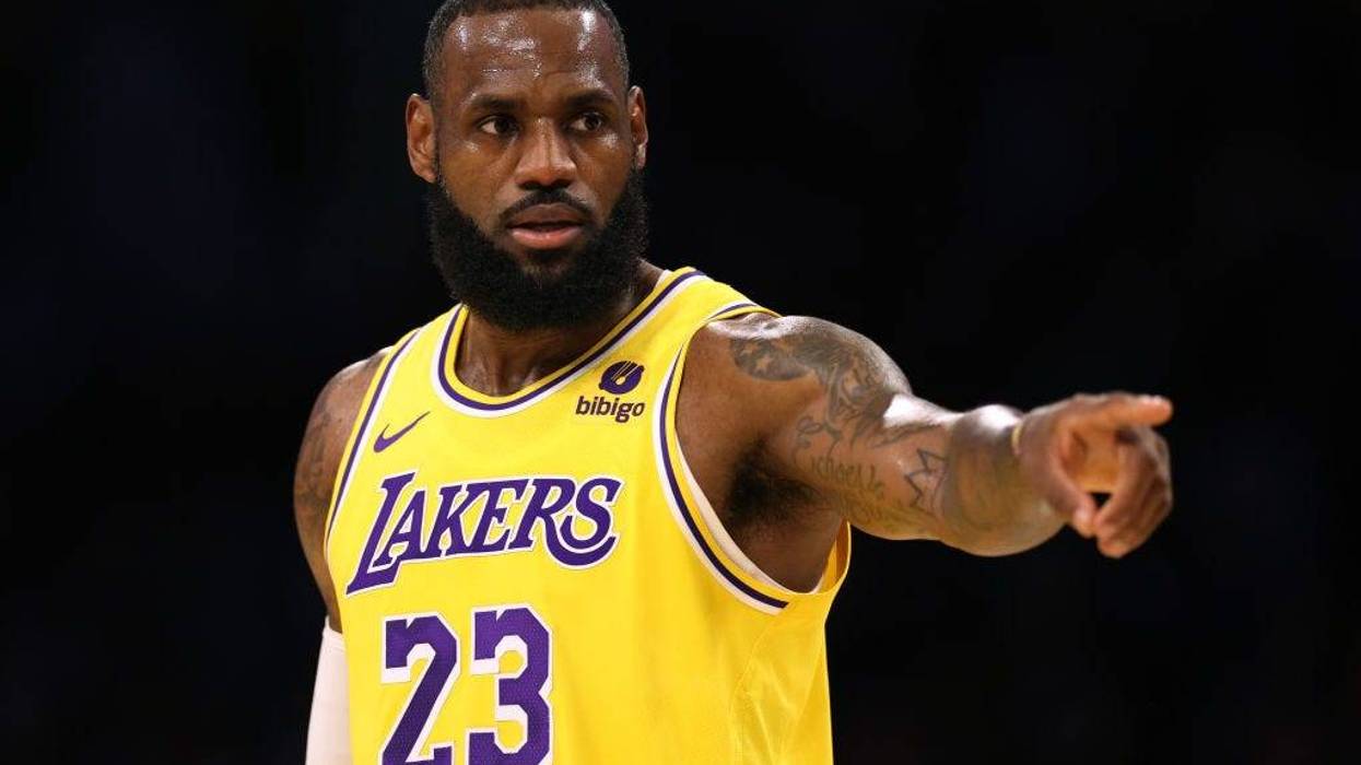 LeBron James #23 of the Los Angeles Lakers directs the defense during a 129-125 loss to the Golden State Warriors in a preseason game at Crypto.com Arena on October 13, 2023 in Los Angeles, California.