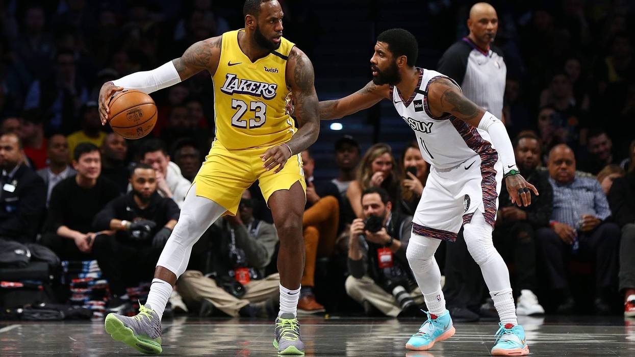 LeBron James #23 of the Los Angeles Lakers posts up against Kyrie Irving #11 of the Brooklyn Nets at Barclays Center on January 23, 2020 in New York City.
