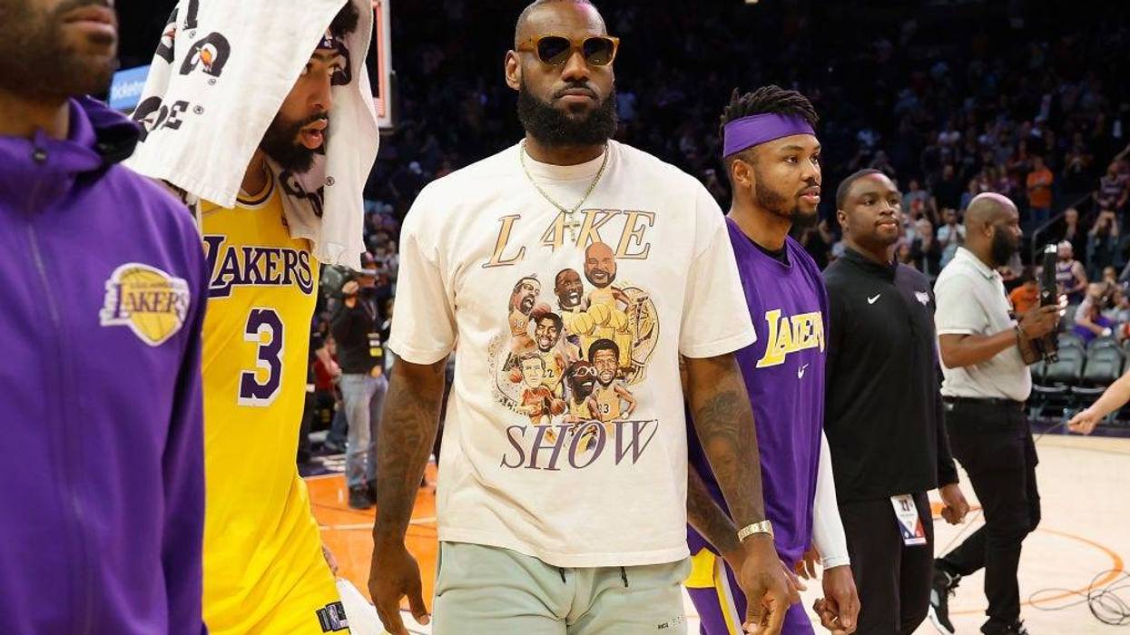 LeBron James #6 and Anthony Davis #3 of the Los Angeles Lakers walk off the court following the NBA game at Footprint Center on April 05, 2022 in Phoenix, Arizona.