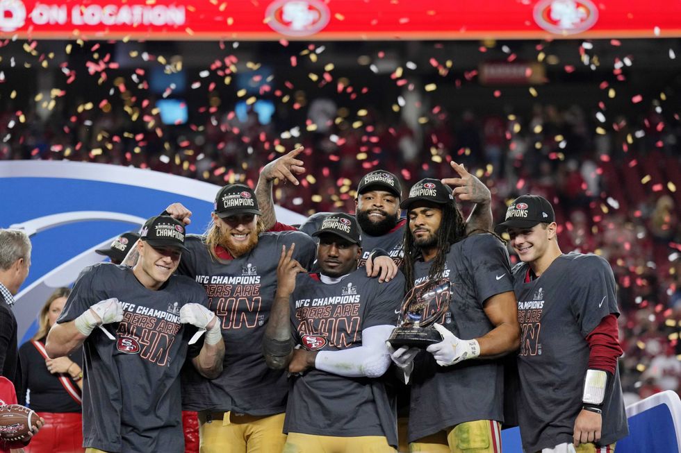 (Left to right) San Francisco 49ers running back Christian McCaffrey (23), tight end George Kittle (85), offensive tackle Trent Williams (71), wide receiver Deebo Samuel (19), and linebacker Fred Warner (54), and quarterback Brock Purdy (13) celebrate after winning the NFC Championship football game against the Detroit Lions at Levi