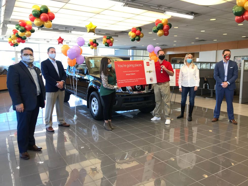 (Left to right) Wells Fargo representatives, Sheena and Jesse Odom, Military Warriors Support Foundation representative, and Benson Nissan of Easley GM Ashby Crow all pose in front of the donated 2020 Nissan Frontier.