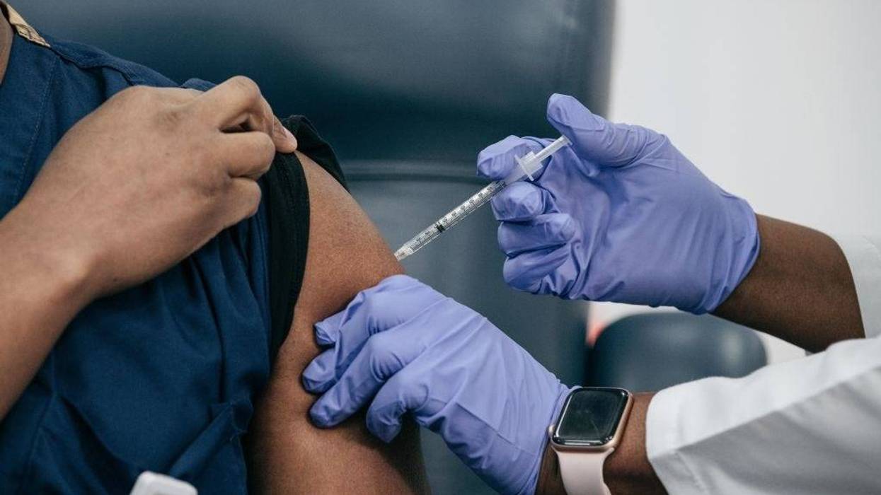 Lenox Hill Hospital Chair of Emergency Medicine Yves Duroseau receives the COVID-19 vaccine from Doctor Michelle Chester at Long Island Jewish Medical Center on December 14, 2020 in New Hyde Park on Long Island, New York.