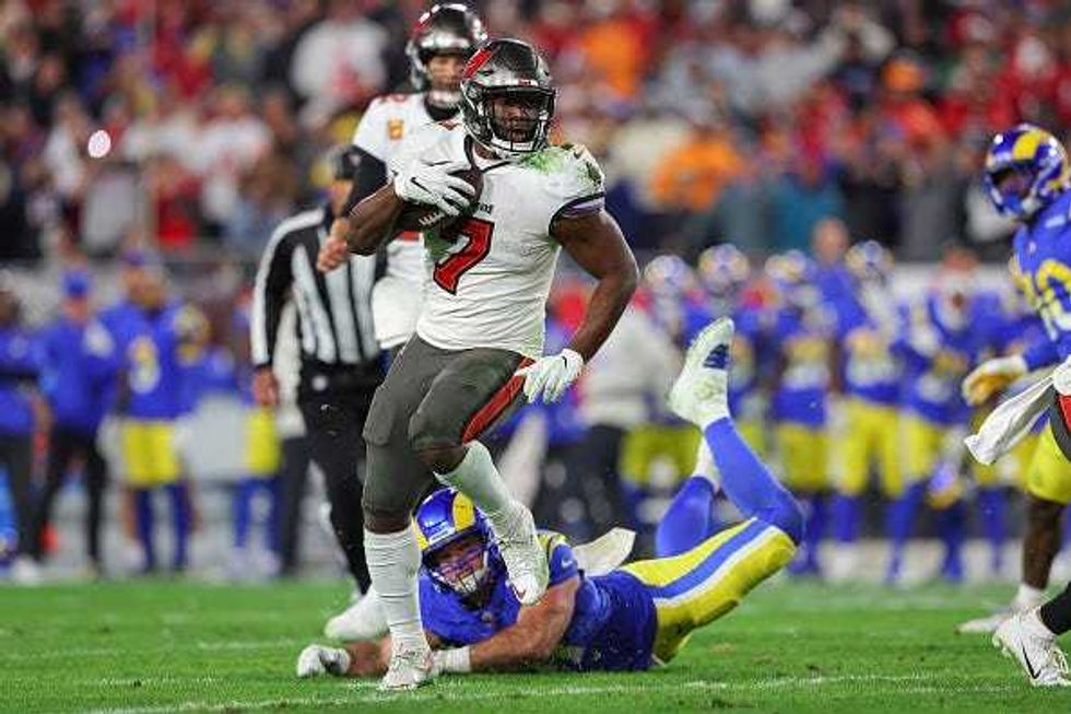 Leonard Fournette escapes a tackle in a Bucs game.