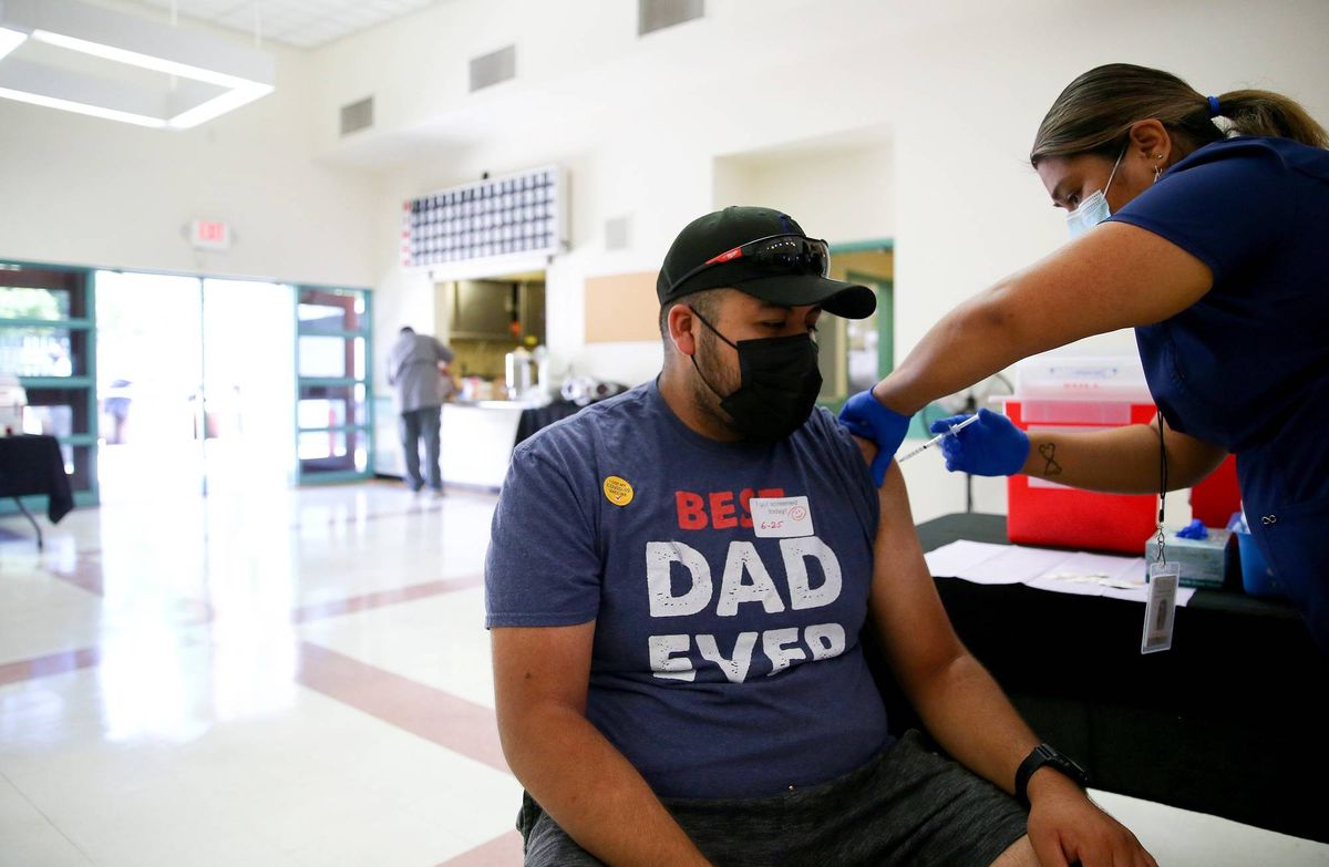 Leslie Garcia administers a COVID-19 vaccination dose to Raul Zarate at a clinic in South Los Angeles on June 25, 2021 in Los Angeles, California.