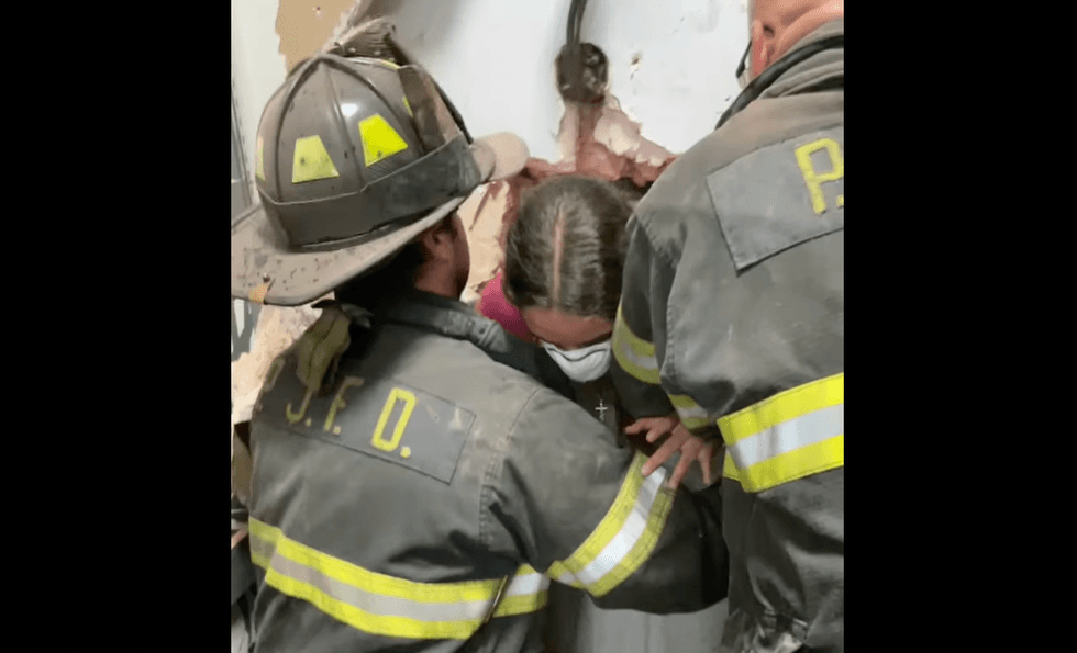 VIDEO: Firefighters drill through wall to rescue girl trapped in store's dressing room