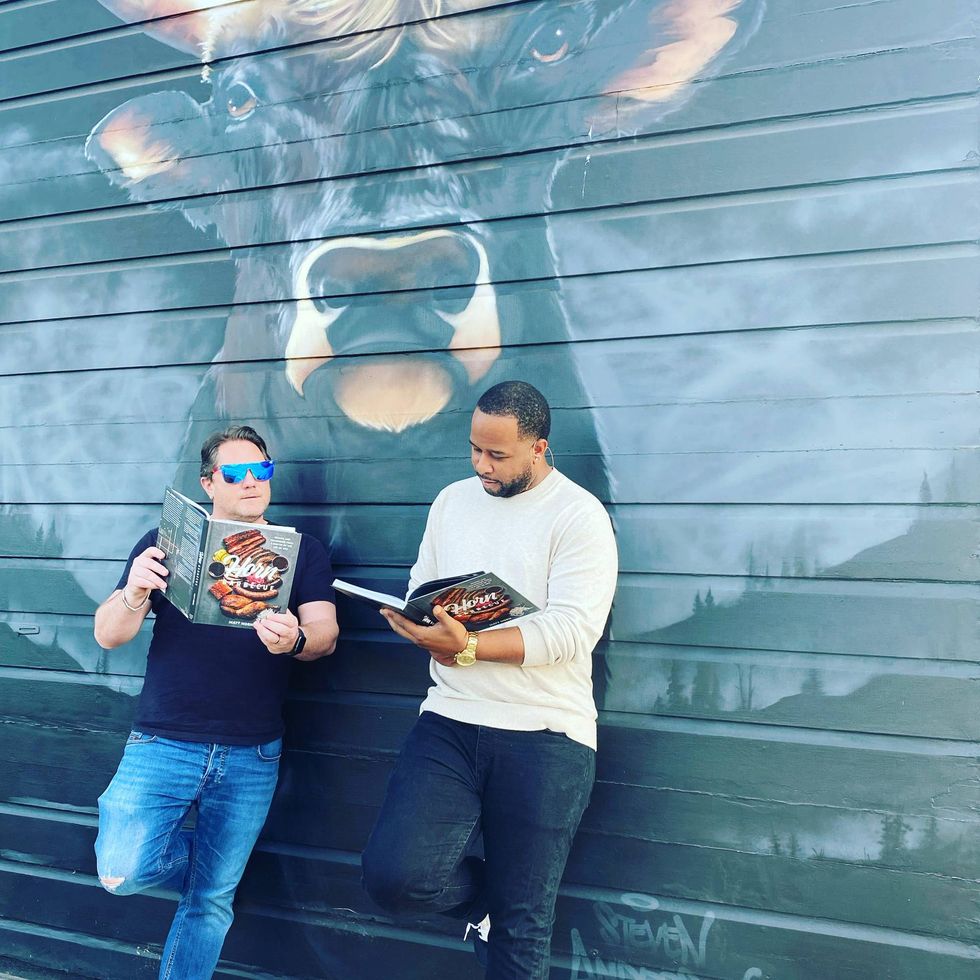 Liam and chef Matt Horn outside Horn Barbecue and reading