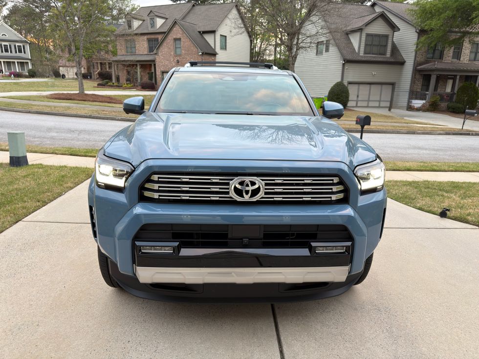 Light blue Toyota 4Runner SUV, pickup truck, front view, on a driveway.