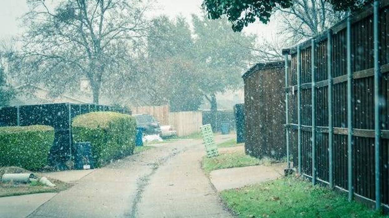 Light snowing over back alley of residential neighborhood suburbs Dallas, Texas