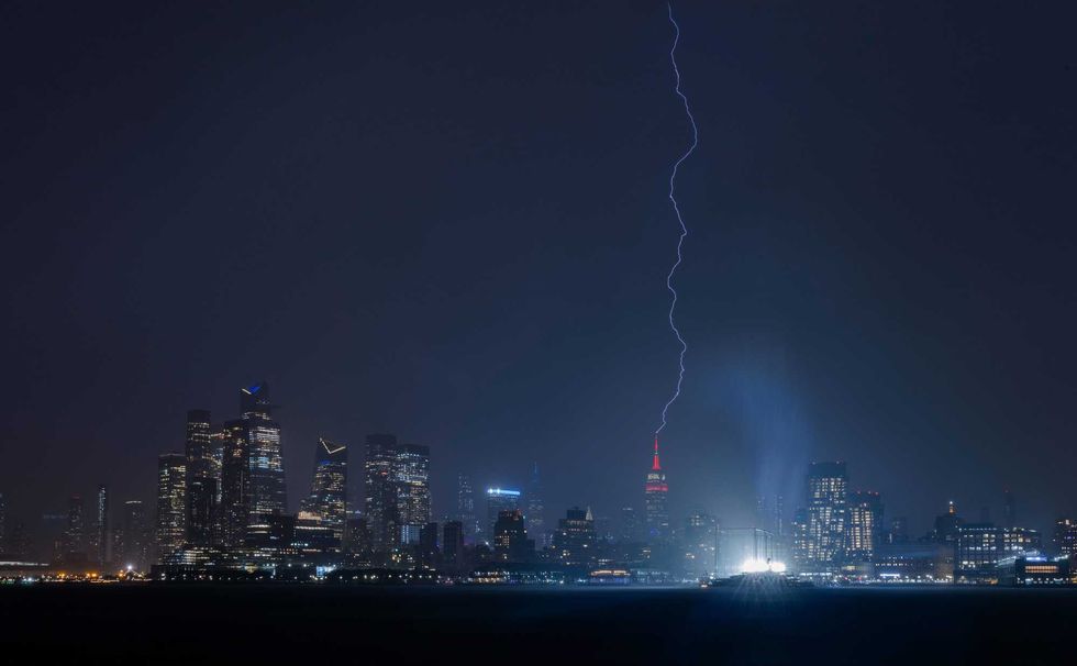 Lightning strikes the Empire State Building in New York City during a thunderstorm on May 29, 2024, as seen from Hoboken, New Jersey