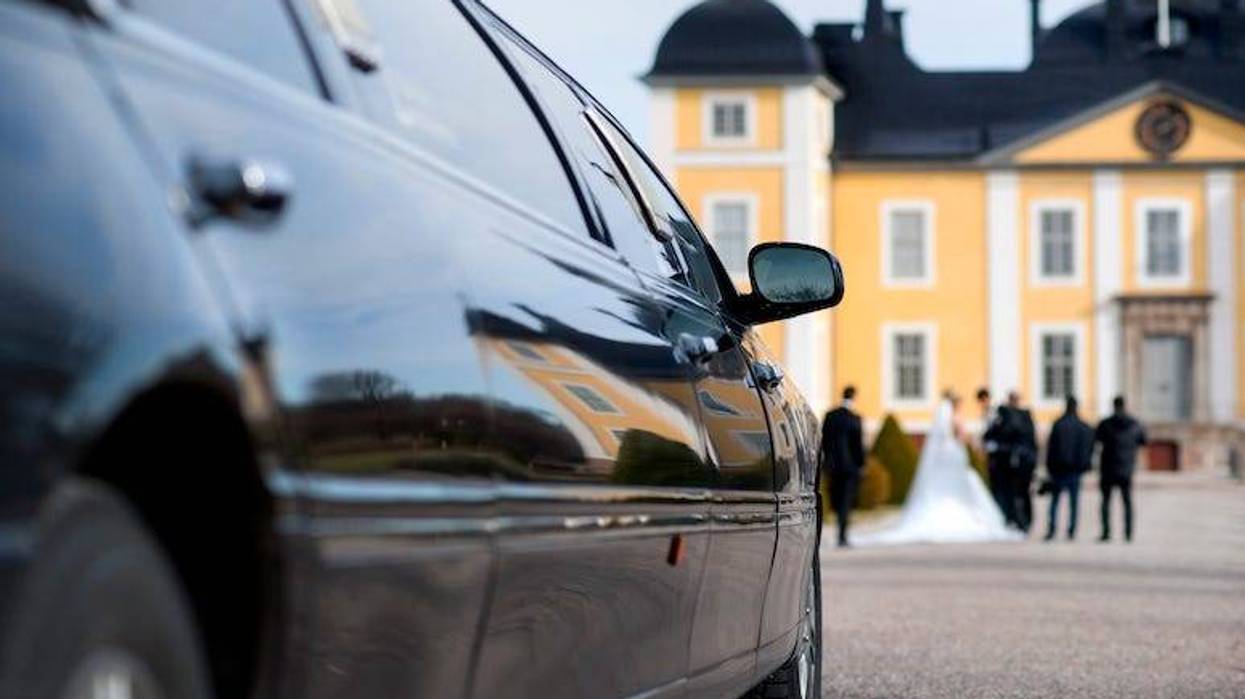 Limo in front of mansion during wedding