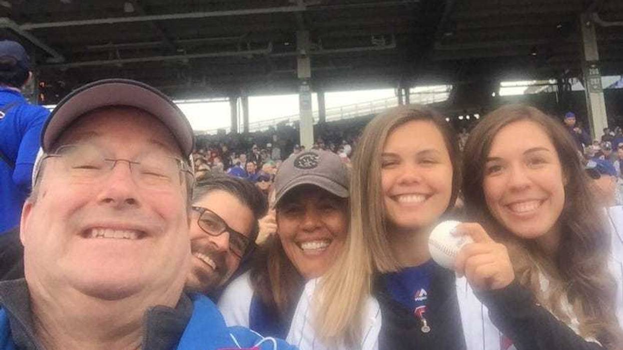 Lin Brehmer, left, and the Spiegel family enjoy a Cubs game together.