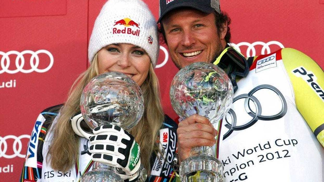 Lindsey Vonn, of the United States, left, and Norway's Aksel Lund Svindal pose with their trophies of the alpine ski, women's and men's World Cup super-G discipline titles, in Schladming, Austria.