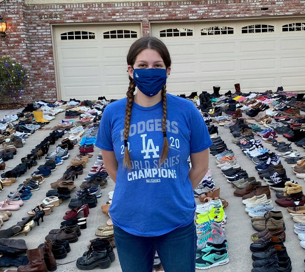 Lindsey with pairs of shoes lined up behind her