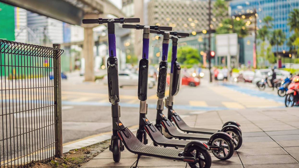 Line of Bird scooters on city sidewalk