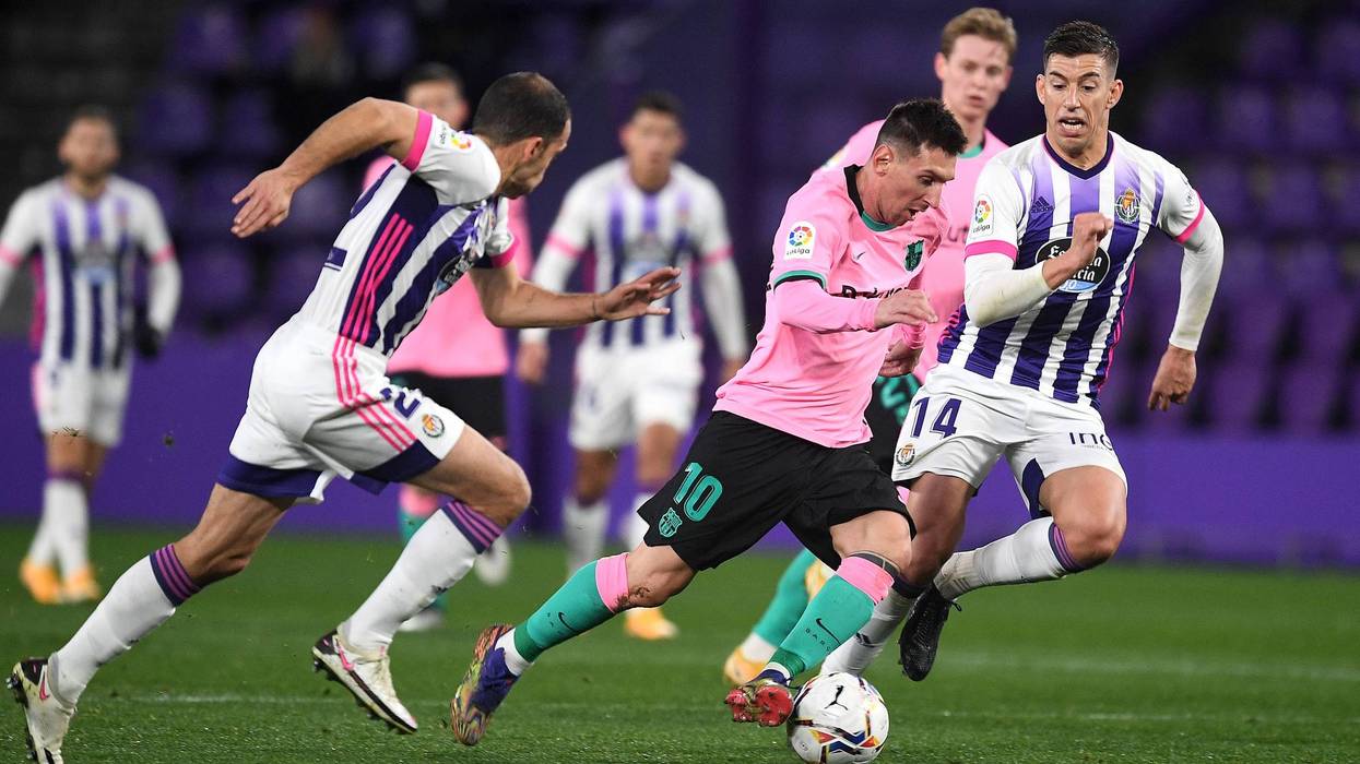 Lionel Messi of Barcelona breaks away from Ruben Alcaraz of Valladolid during the La Liga Santander match between Real Valladolid CF and FC Barcelona at Estadio Municipal Jose Zorrilla on December 22, 2020 in Valladolid, Spain.