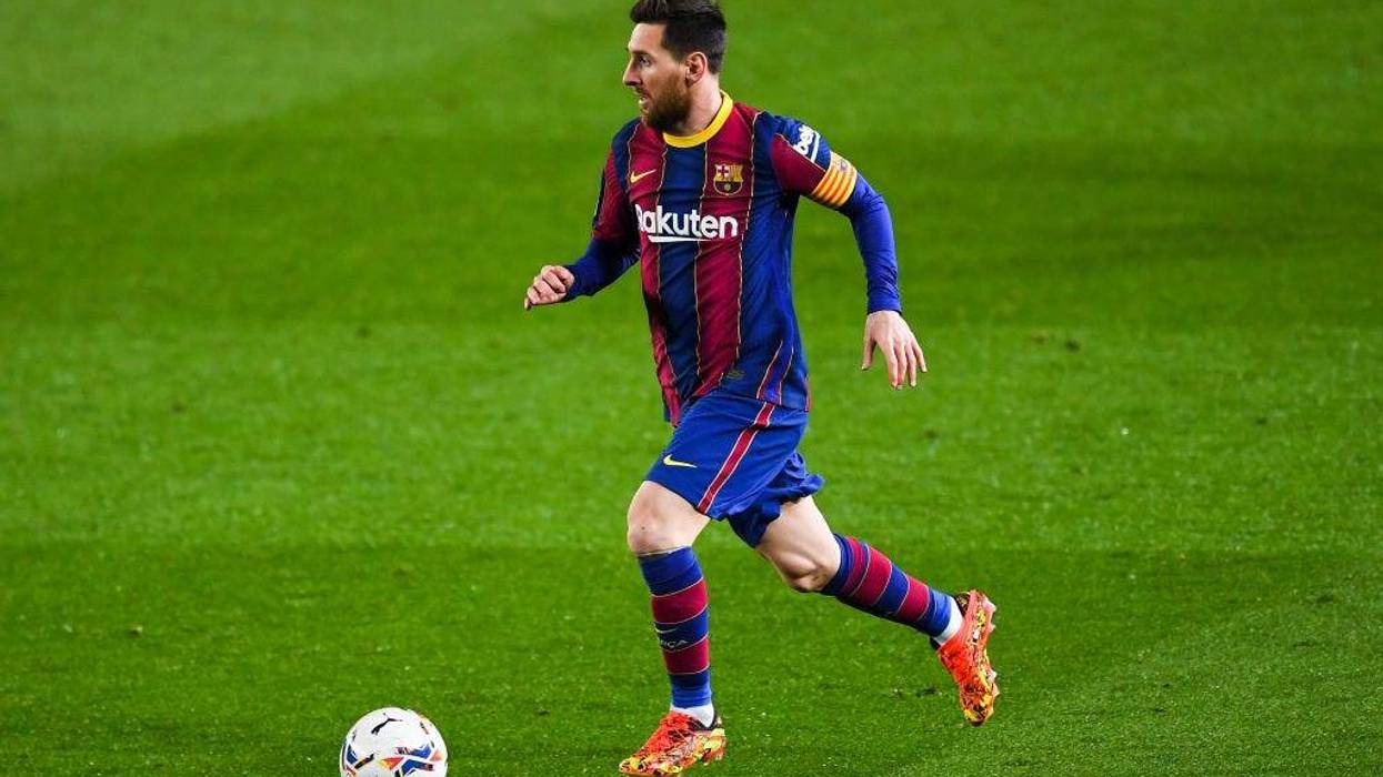 Lionel Messi of FC Barcelona runs with the ball during the La Liga Santander match between FC Barcelona and SD Huesca at Camp Nou on March 15, 2021 in Barcelona, Spain. Sporting stadiums around Spain remain under strict restrictions due to the Coronavirus Pandemic as Government social distancing laws prohibit fans inside venues resulting in games being played behind closed doors.