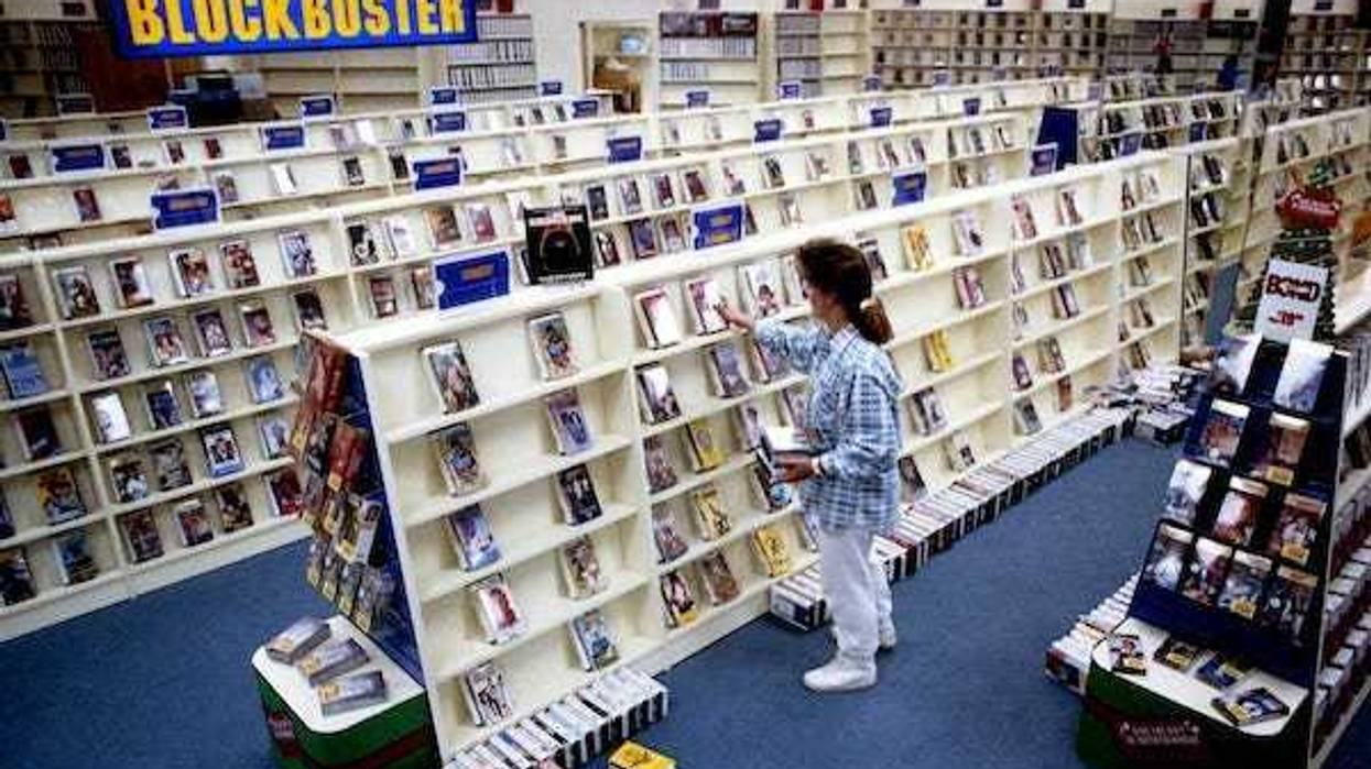 Lisa Morse, assistant manager of the new Blockbuster Video store in the City Square shopping center in Hendersonville, Tenn., stocks shelves in the comedy section Dec. 12, 1990