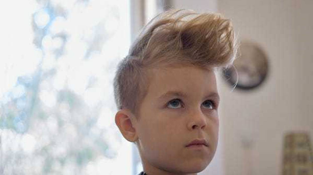 Little boy with hairstyle getting haircut
