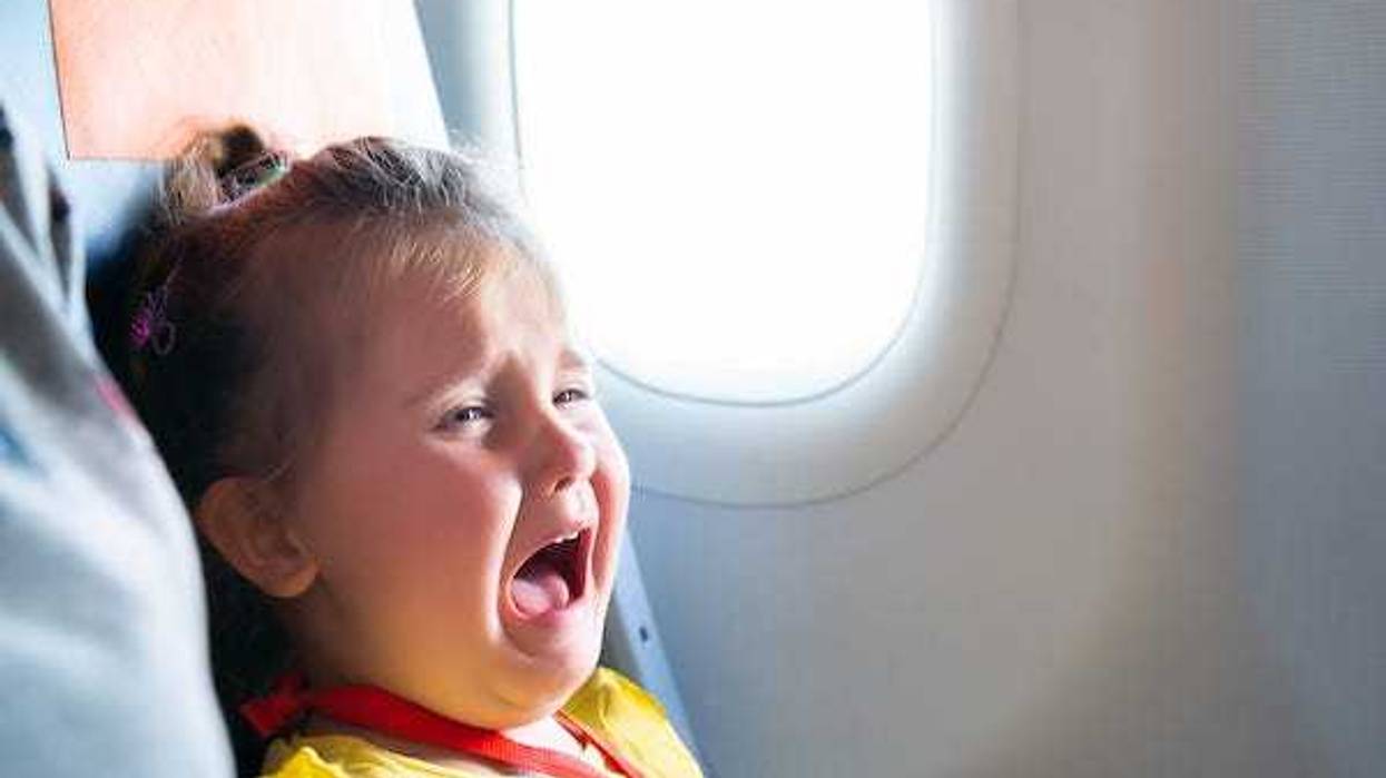 Little girl crying on a plane