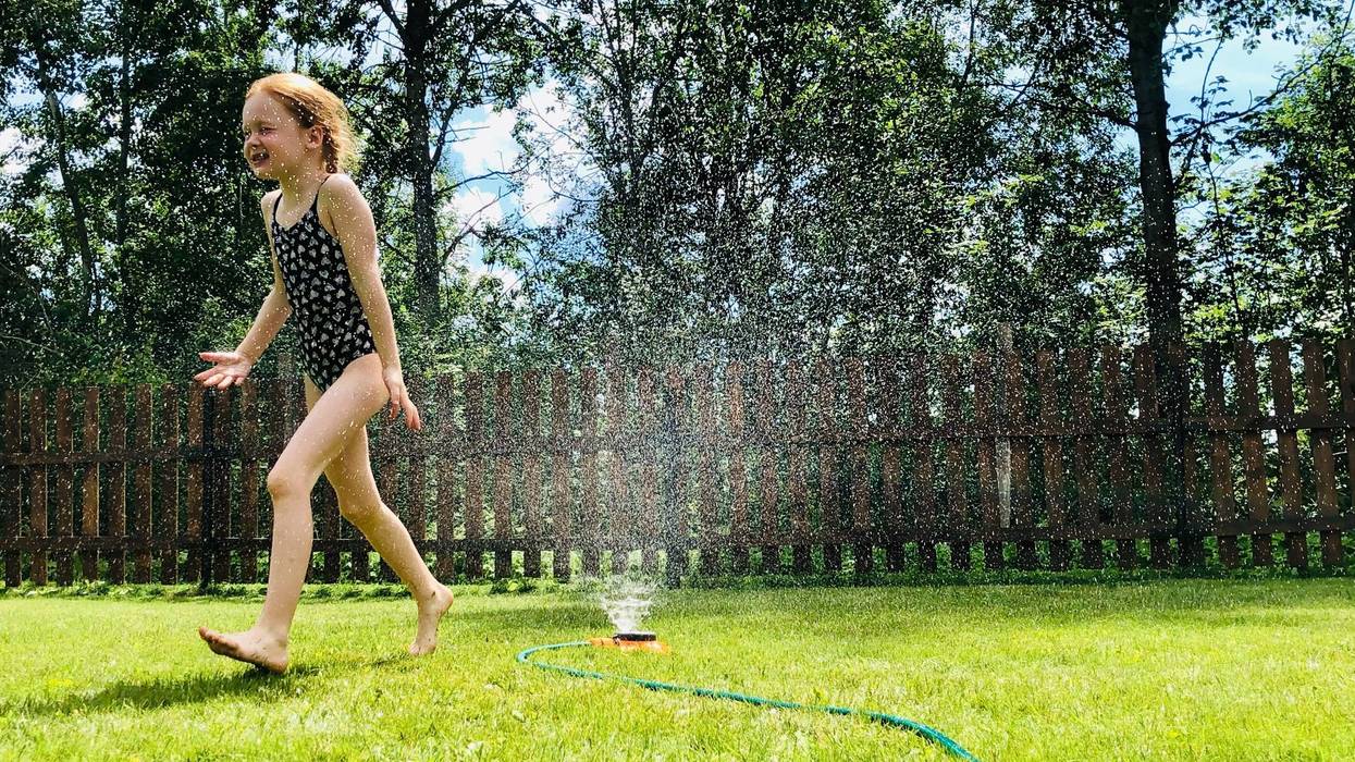 little girl playing in the sun outside