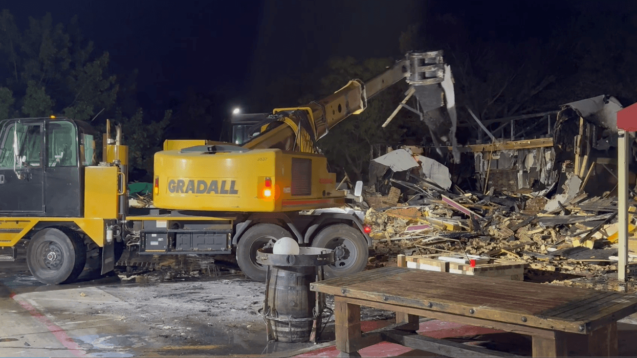 Little remains of the Beirut Grill in west Arlington after a four-alarm fire tore through a one-story commercial building Monday evening during triple-digit heat. Several neighboring businesses in the same strip were also damaged.