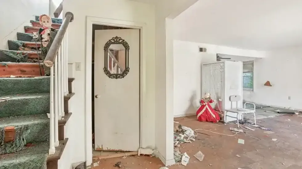 Living room with creepy doll in it.