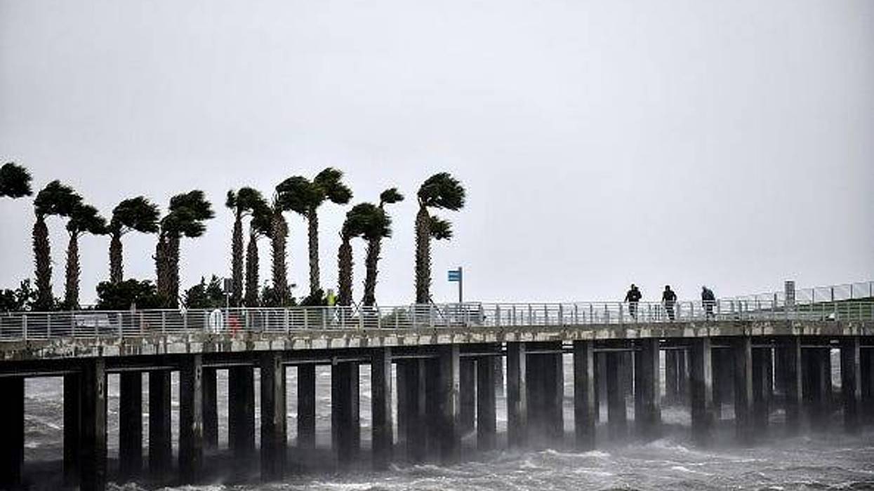 Local residents walk in the middle of the rain and heavy wind at the St. Pete pier as Hurricane Ian hits the west coast on Sept. 28, 2022, in St. Petersburg, Florida. Ian is hitting the area as a likely Category 4 hurricane.