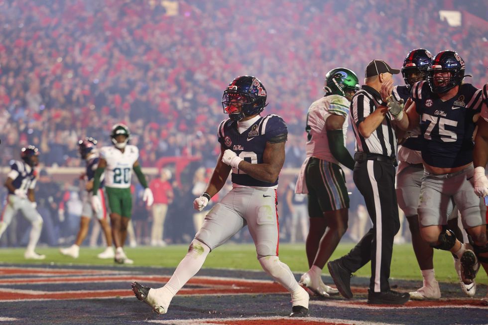 Logan Diggs #22 of the Ole Miss Rebels celebrates after scoring a touchdown during the fourth quarter of the 2025 College Football Playoff First Round Game against the Tulane Green Wave at Vaught-Hemingway Stadium on December 20, 2025 in Oxford, Mississippi.