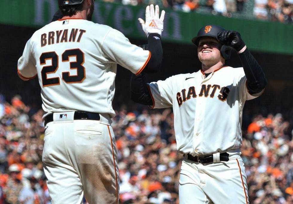 Logan Webb #62 of the San Francisco Giants hits a home run in the fifth inning against the San Diego Padres at Oracle Park on October 03, 2021 in San Francisco, California.