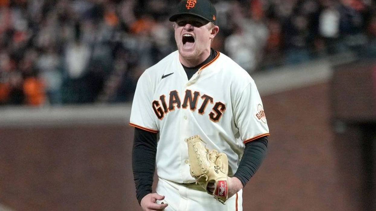 Logan Webb #62 of the San Francisco Giants reacts after striking out Cody Bellinger #35 of the Los Angeles Dodgers at the top of the seventh inning in game 5 of the National League Division Series at Oracle Park on October 14, 2021 in San Francisco, California.