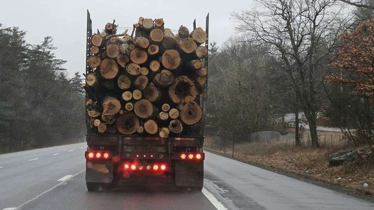 Logging truck drives away