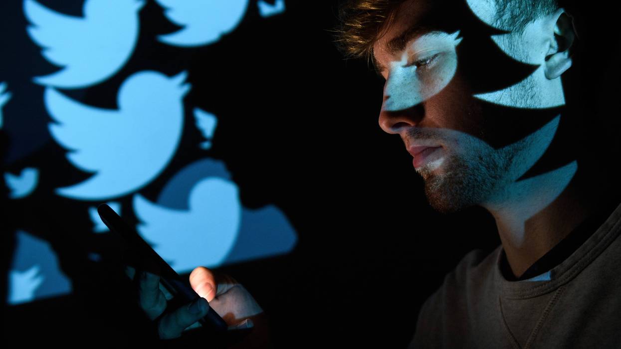LONDON, ENGLAND - AUGUST 09: In this photo illustration, the logo for the Twitter social media network is projected onto a man on August 09, 2017 in London, England. With around 328 million users worldwide, Twitter has gone from a small start-up in for the public 2006 to a broadcast tool of politicians and corporations in 2017.