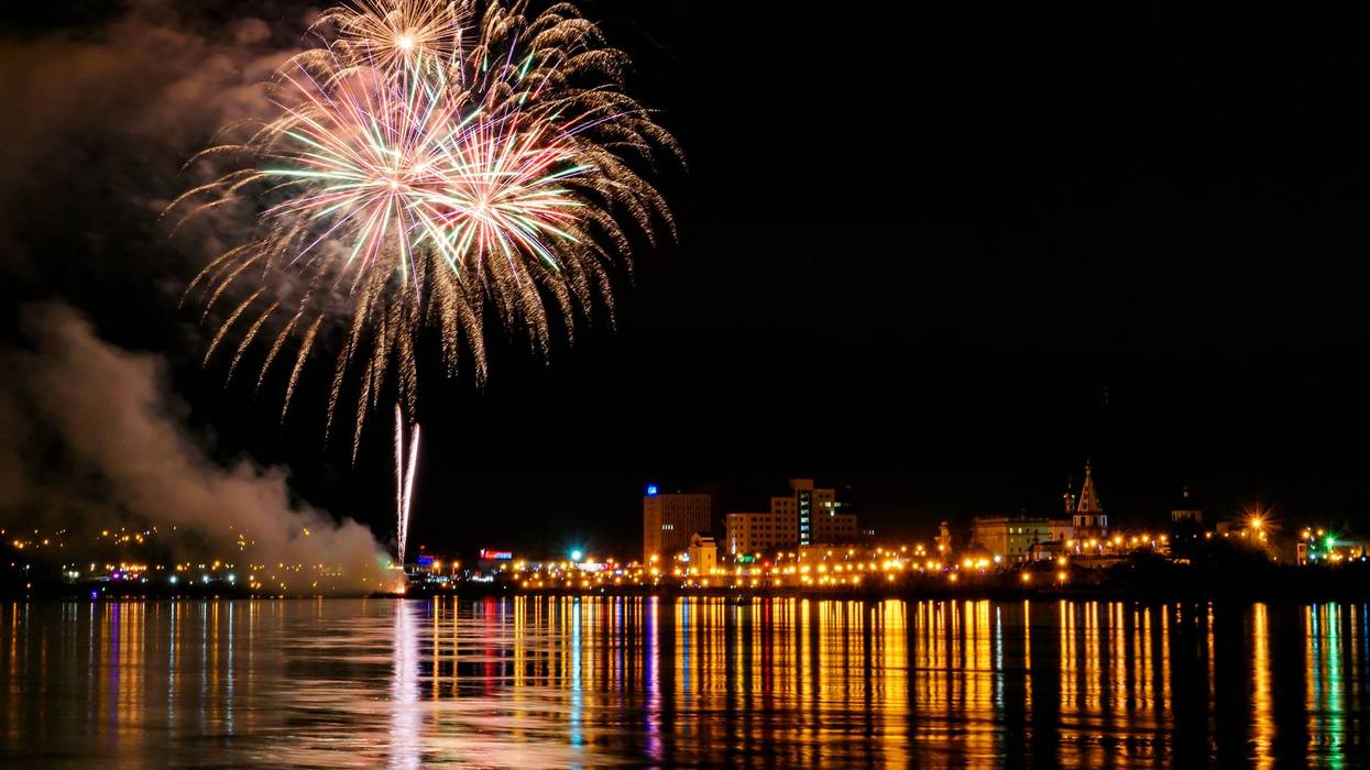 Long Exposure of Fireworks Reflecting on Calm Rippling Water