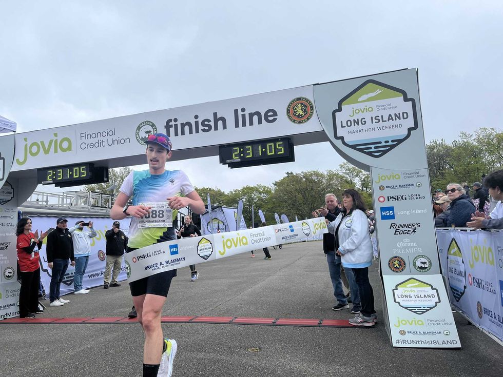 Long Island Marathon winner Ryan Clifford crossing the finish line.