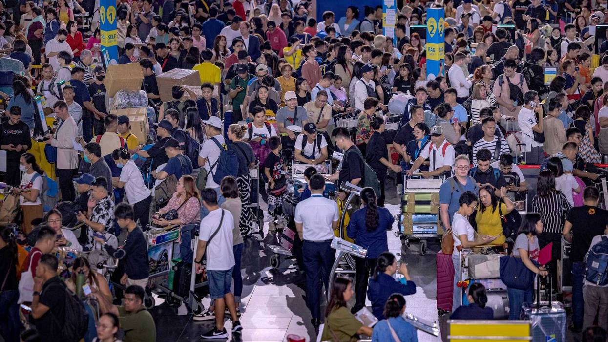 Long queues of passengers form at the check-in counters at Ninoy Aquino International Airport, amid a global IT disruption caused by a Microsoft outage and a Crowdstrike IT problem, on July 19, 2024 in Manila, Philippines
