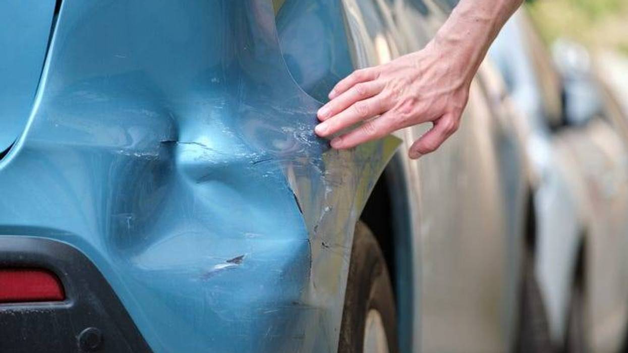 Looking At A Dented Car