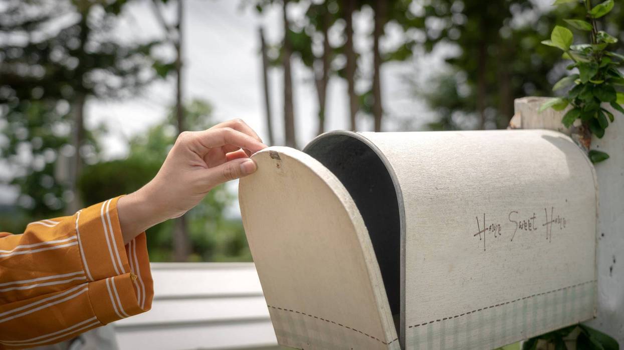 Looking in mailbox stock photo.