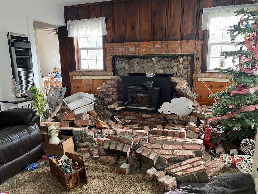 Looking through the home, the living room was covered in old bricks and the wall where they stood was stripped bare.