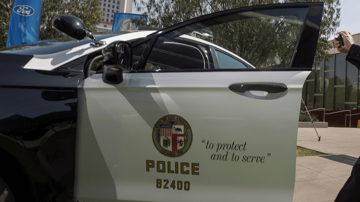 LOS ANGELES, CA - APRIL 10: An LAPD officer makes a smart phone video at the unveiling of two new Ford Fusion hybrid pursuit-rated Police Responder cars at Los Angeles Police Department headquarters on April 10, 2017 in Los Angeles, California. The LAPD is committed to purchasing at least 300 hybrid and hybrid-electric plug-in vehicles by 2020.