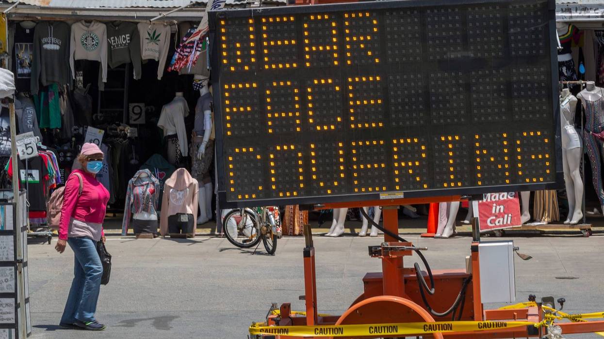 LOS ANGELES, CA - MAY 24: Holiday beachgoers are reminded to keep their faces covered at Venice Beach on Memorial Day as coronavirus safety restrictions continue being relaxed in Los Angeles County and nationwide May 24, 2020 in Los Angeles, California.