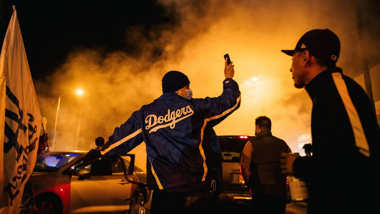 LOS ANGELES, CA - OCTOBER 27: Dodgers fans celebrate after the Los Angeles Dodgers defeated the Tampa Bay Rays 3-1 on October 27, 2020 in Los Angeles, California. Fans gathered at Elysian park for game 6 of the World Series where the Los Angeles Dodgers defeated the Tampa Bay Rays to win the World Series for the first time in 32 years.