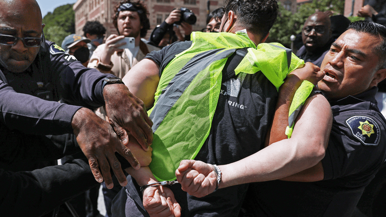 LOS ANGELES, CALIFORNIA - APRIL 24: USC police officers detain a pro-Palestine demonstrator during clashes after officers attempted to take down an encampment in support of Gaza at the University of Southern California on April 24, 2024 in Los Angeles, California. Pro-Palestinian encampments have sprung up at college campuses around the country recently.