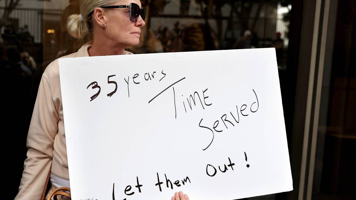 LOS ANGELES, CALIFORNIA - OCTOBER 16: A supporter holds a sign at a press conference with Menendez family members outside the Criminal Courts Building on October 16, 2024 in Los Angeles, California. Members of the Menendez family held the news conference to call for the release of brothers Lyle and Erik Menendez from prison nearly thirty years after their conviction in 1996 for killing their parents in Beverly Hills. The district attorney’s office is looking at new evidence which supports the brothers’ claim they were sexually abused by their father.