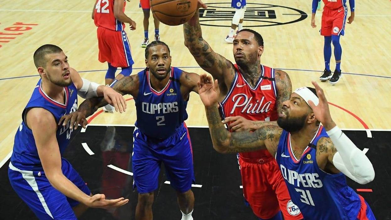Los Angeles Clippers center Ivica Zubac (40) forward Kawhi Leonard (2), and Marcus Morris Sr. (31) and Philadelphia 76ers forward Mike Scott (1) reach for a rebound in the second half of the game at Staples Center.