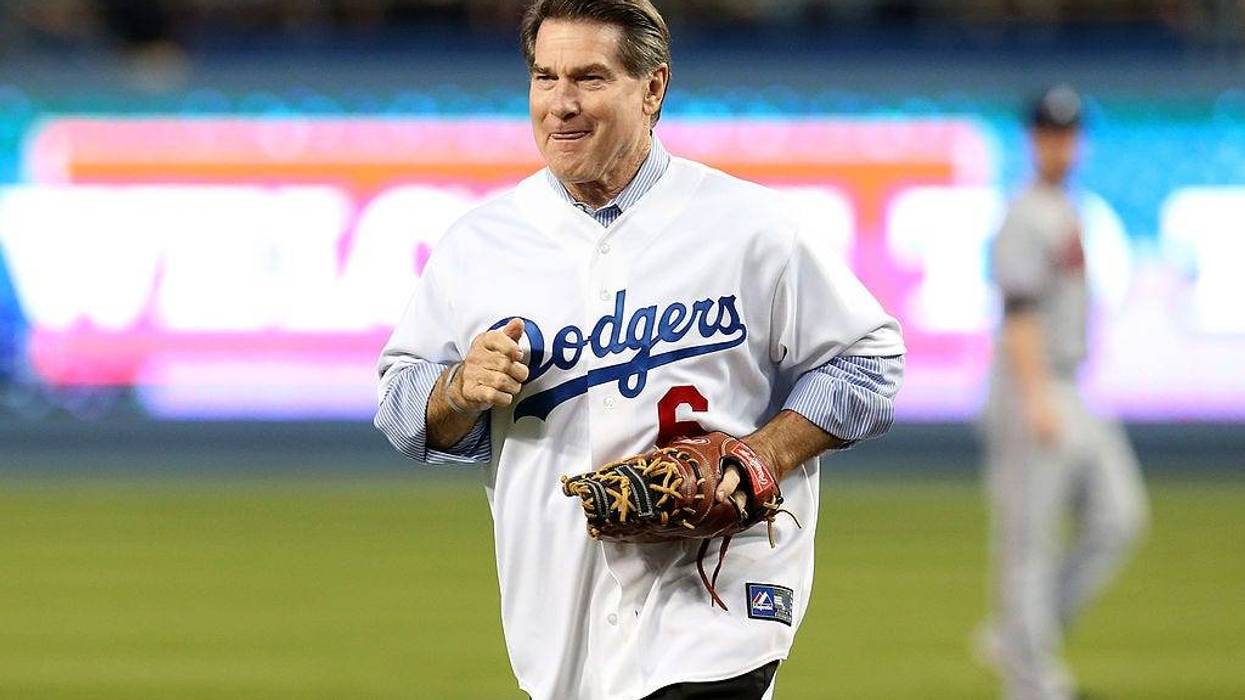 Los Angeles Dodgers legend Steve Garvey throws out a ceremonial first pitch before the Dodgers take on the Atlanta Braves in Game Four of the National League Division Series at Dodger Stadium on October 7, 2013 in Los Angeles, California.