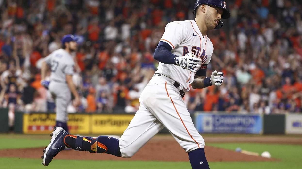 Los Angeles Dodgers starting pitcher Trevor Bauer (27) reacts as Houston Astros shortstop Carlos Correa (1) rounds the bases after hitting a home run during the sixth inning at Minute Maid Park.