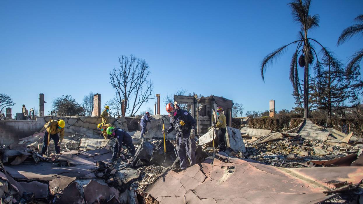 Los Angeles Fire Fighters and Sacramento Fire Fighters Urban Search & Rescue team inspect a burned house from the Palisades Fire in the Pacific Palisades neighborhood on January 16, 2025 in Los Angeles, California.