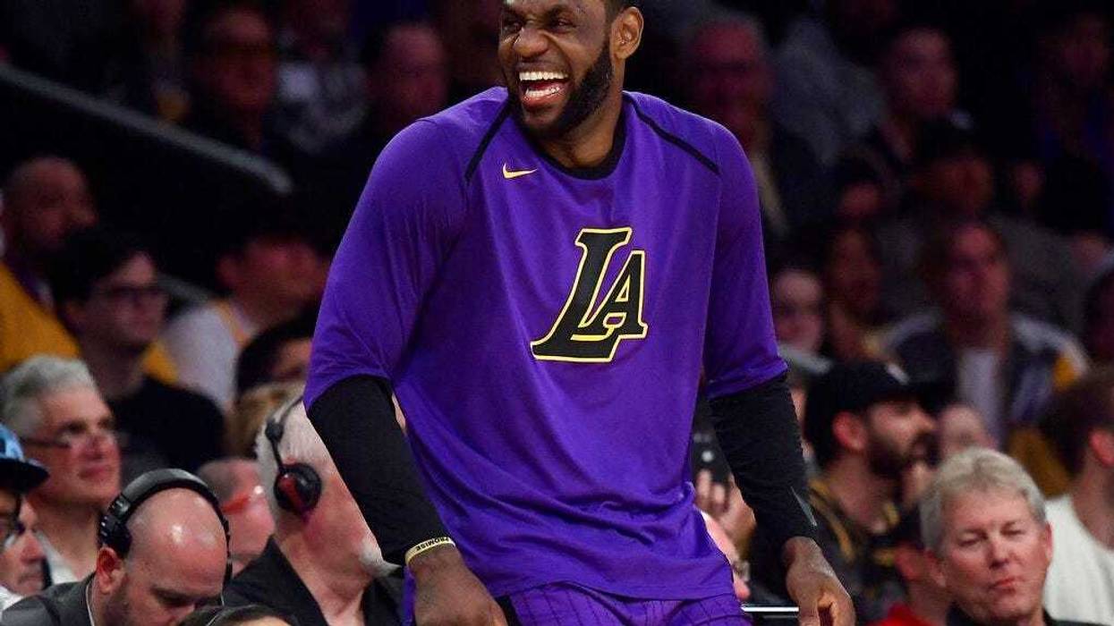 Los Angeles Lakers forward LeBron James laughs as he waits to check in to the team's NBA basketball game against the Charlotte Hornets during the second half Friday, March 29, 2019, in Los Angeles. The Lakers won 129-115.